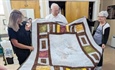 A quilt for Father George Fagan: Members of Seven Sisters Apostolate cover retired priest in prayer, warmth
