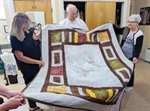 A quilt for Father George Fagan: Members of Seven Sisters Apostolate cover retired priest in prayer, warmth